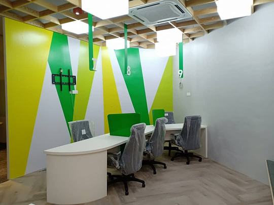 Grab office feature wall — Angular graphic wallcovering behind the service desks by Sunshine Advertising & Media